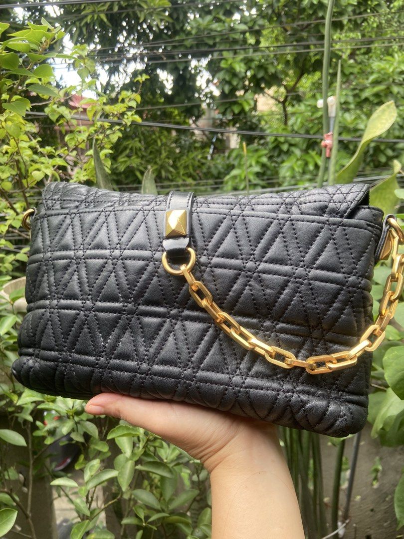 Marc by Marc Jacobs Quilted Black Leather Shoulder Bag (Category: Luxury Bags & Wallets) located in Rizal. Submitted by rosemarievillaluna176 (Listing ID 1467011344, Image 2). Description: - Brand: Marc by Marc Jacobs - Material: Black quilted leather with triangular stitched pattern - Hardware: Gold-tone accents with chunky chain strap - Closure: Flap closure with leather strap and pyramid stud detail - Special Feature: Unique marbled accent pla