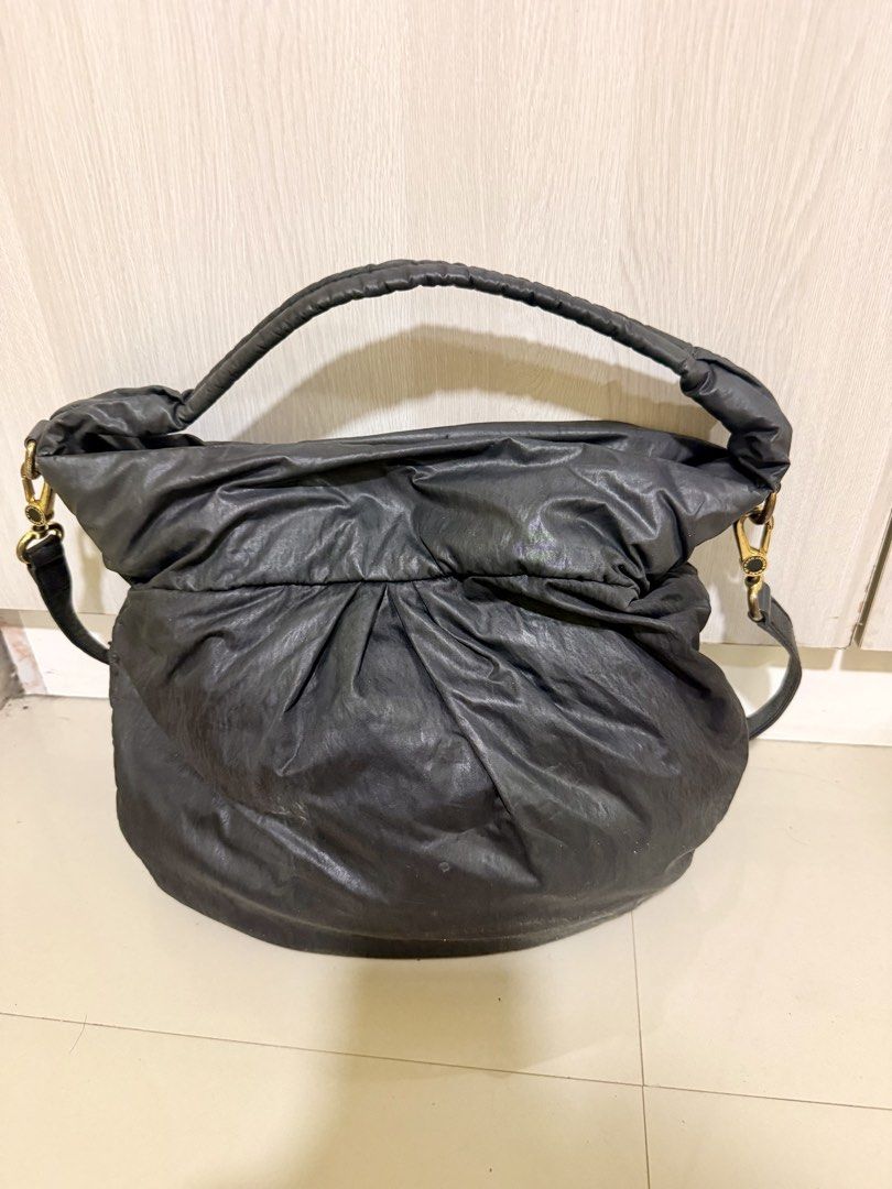 Marc by Marc Jacobs Workwear Nylon Shoulder Bag Black (Category: Luxury Bags & Wallets) located in Manila. Submitted by rrtolibas48132 (Listing ID 1467065048, Image 2). Description: - Brand: Marc by Marc Jacobs - Color: Classic Black with gold-tone hardware - Material: Durable nylon with leather detachable crossbody strap - Design: Gathered ruched styling with structured top handle and front metal workwear standard supply plaque - Interior: Zip c