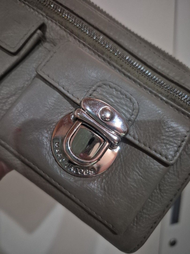 Marc Jacobs Grey Leather Zip Around Wallet (Category: Wallets & Card holders) located in Iloilo. Submitted by gorgeoustatz (Listing ID 1467040026, Image 3). Description: - Brand: Marc Jacobs - Material: Soft grained grey leather with silver hardware - Closure: Secure zip-around design - Exterior: Two small turn-lock pockets on the front and one zip compartment - Interior: Plenty of compartments for cards and cash - Condition: Visible wear on edge