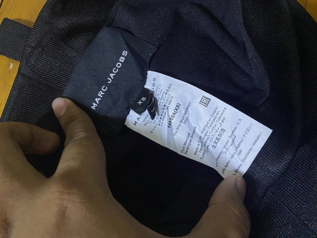 Marc Jacobs The Bike Short Black Size XS (Category: Shorts) located in San Jose del Monte. Submitted by dripfromthrift2 (Listing ID 1467060921, Image 3). Description: - Brand: Marc Jacobs - Item: The Bike Short - Color: Black - Size: XS (155/68AXS) - Material: 64% viscose, 33% nylon, 3% elastane - Features: Ribbed knit fabric with contrast white Marc Jacobs logo text near the hem - Origin: Made in Turkey - Care Instructions: Hand wash cold only.