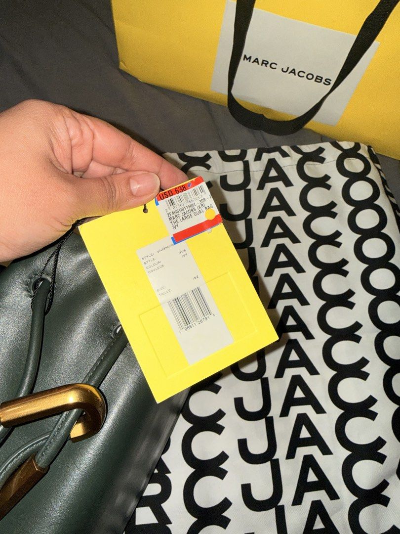 Marc Jacobs The Large Dual Bag Ivy (Category: Luxury Bags & Wallets) located in Pasay City. Submitted by ccpetitte (Listing ID 1466971304, Image 3). Description: - Brand: Marc Jacobs - Model: The Large Dual Bag - Color: Ivy Green with gold-tone hardware - Condition: Brand new, never used, pristine condition - Inclusions: Original retail tag (USD 638), branded dust bag, and shopping bag - Features: Unique strap design and premium leather.