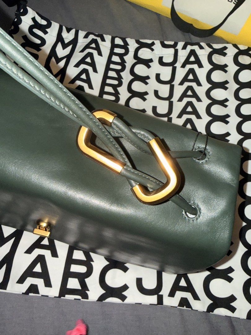 Marc Jacobs The Large Dual Bag Ivy (Category: Luxury Bags & Wallets) located in Pasay City. Submitted by ccpetitte (Listing ID 1466971304, Image 2). Description: - Brand: Marc Jacobs - Model: The Large Dual Bag - Color: Ivy Green with gold-tone hardware - Condition: Brand new, never used, pristine condition - Inclusions: Original retail tag (USD 638), branded dust bag, and shopping bag - Features: Unique strap design and premium leather.