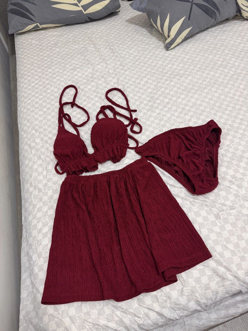Maroon 3-Piece Bikini Set with Skirt (Category: Bikinis & Swimsuits) located in Cavite. Submitted by zealtree.39df52 (Listing ID 1467110794, Image 2). Description: - Color: Deep maroon - Style: 3-piece swimwear set (halter bikini top, matching bottoms, lightweight skirt wrap) - Fabric: Textured crinkle material - Closure: Adjustable tie straps at neck and back - Condition: used once / Ready for travel.