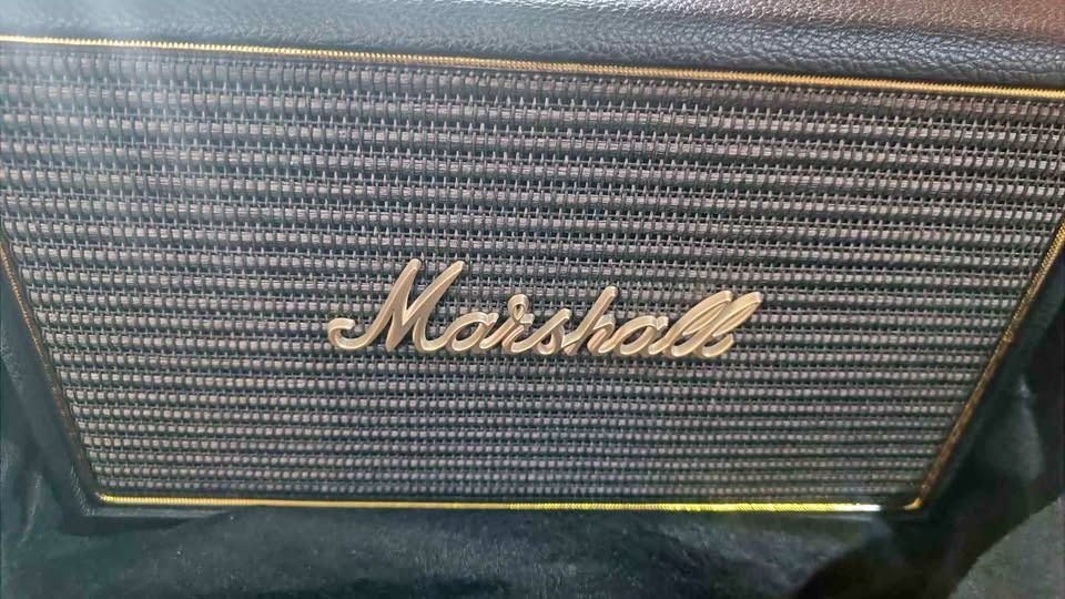 Marshall Acton Multi Room Wifi Speaker (Category: Soundbars, Speakers & Amplifiers) located in Cebu City. Submitted by buddylimong (Listing ID 1467019964, Image 1). Description: Marshall Acton wireless speaker in black. Iconic vintage design with gold accents and the classic script logo on the front grille. Top control panel has physical brass-finish knobs for volume, bass, and treble, alongside the source toggle, 3.5mm auxiliary input, and indic