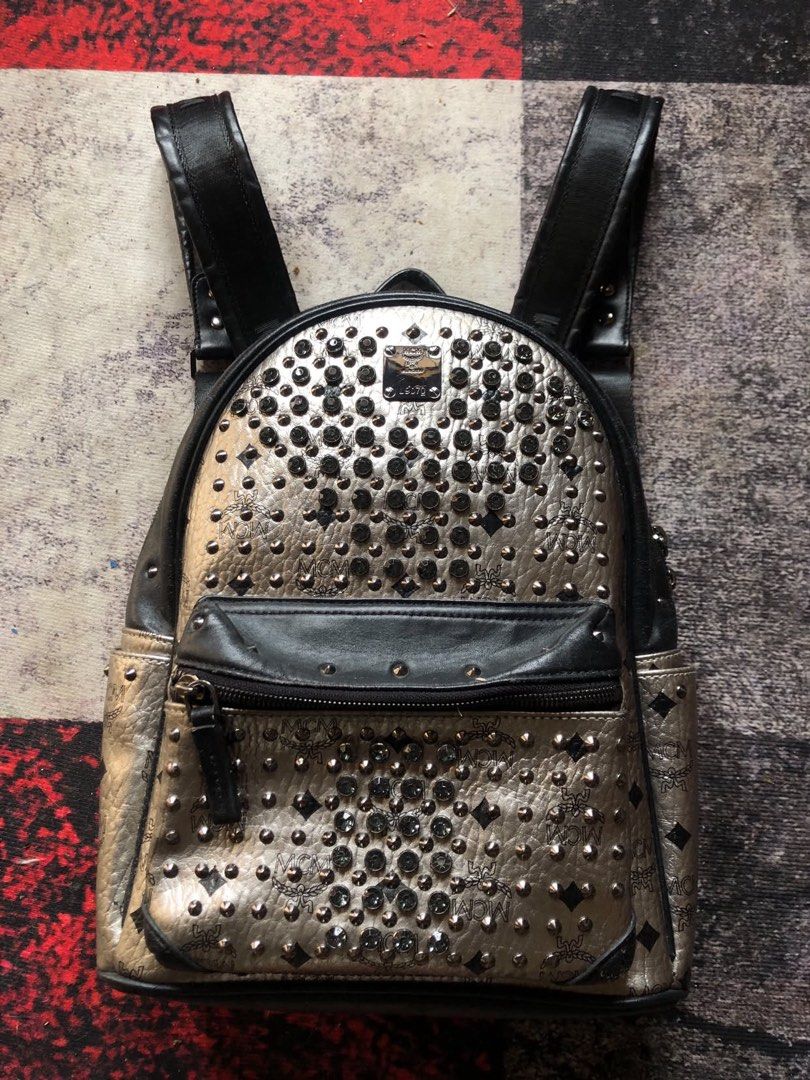 MCM Backpack (Category: Luxury Bags & Wallets) located in Manila. Submitted by pinkmanotrey (Listing ID 1467028500, Image 1). Description: Authentic • Brand / Model: MCM Silver Monogram Crystal-Studded Mini/Small Backpack (such as the MCM Stark or Diamond Visetos line). • Key Features: Metallic silver coated canvas/leather featuring the MCM monogram, black leather front pocket and trim, black crystal or metal stud embellishments throughout, and a