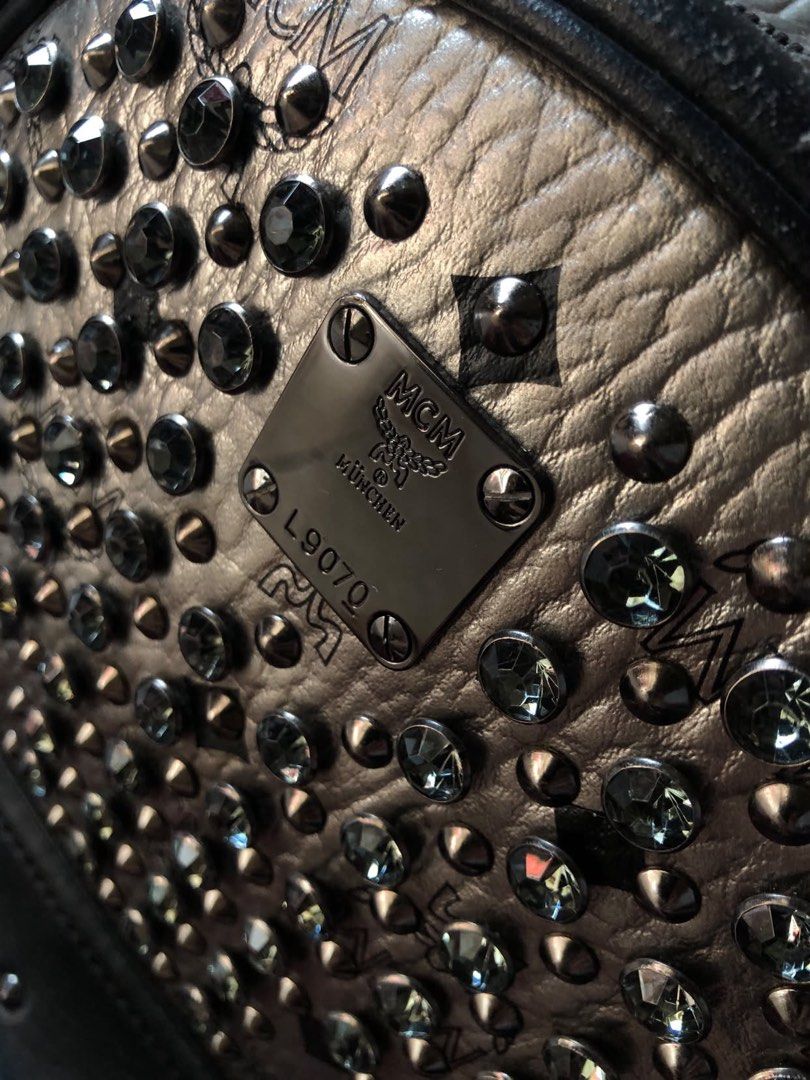 MCM Backpack (Category: Luxury Bags & Wallets) located in Manila. Submitted by pinkmanotrey (Listing ID 1467028500, Image 3). Description: Authentic • Brand / Model: MCM Silver Monogram Crystal-Studded Mini/Small Backpack (such as the MCM Stark or Diamond Visetos line). • Key Features: Metallic silver coated canvas/leather featuring the MCM monogram, black leather front pocket and trim, black crystal or metal stud embellishments throughout, and a