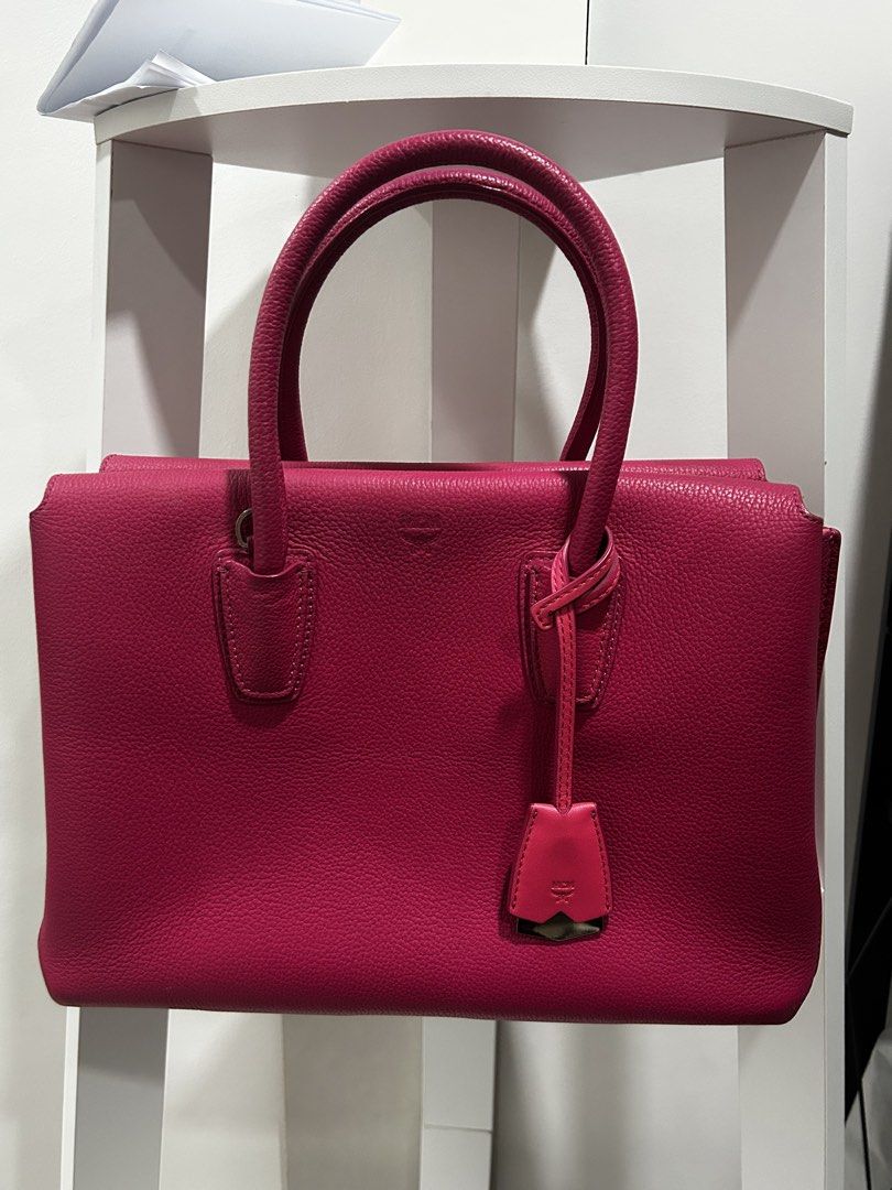 MCM Pink Milla Leather Tote Bag with Orig Dustbag (Category: Luxury Bags & Wallets) located in Rizal. Submitted by bebangel (Listing ID 1467100618, Image 1). Description: - Brand: MCM - Material: Pebbled leather in a vibrant bright pink - Features: Dual top handles, hanging charm with embossed logo hardware, structured shape, clean stitching - Condition: Overall clean exterior and handles, with a minor scuff mark on one bottom corner and a small 