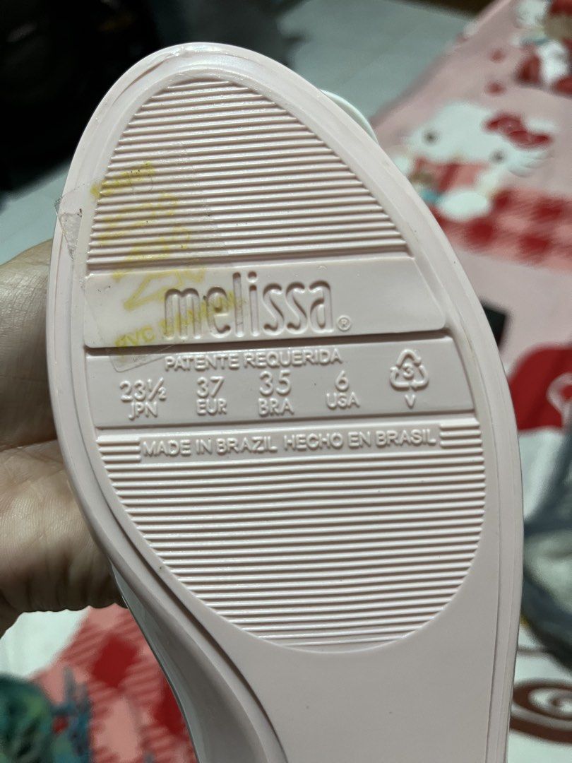 Melissa x Hello Kitty Pink Jelly Flats (Category: Flats & Sandals) located in Manila. Submitted by janetecson05 (Listing ID 1467060749, Image 2). Description: - Brand: Melissa x Kitty - Style: Pink jelly flats with adorable 3D Kitty head and pink bow - Details: Striped pink/white graphic insoles with Sanrio copyright info - Size: US 6 / EUR 37 / JPN 23.5 - Origin: Made in Brazil - Inclusions: Original black Melissa branded shoebox - Condition: Ex