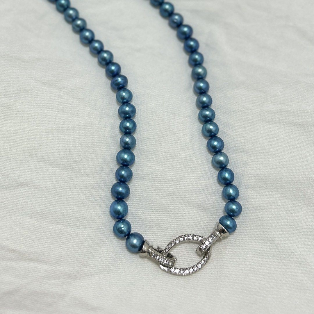 Metallic blue Pearl necklace (Category: Necklaces) located in Lipa City. Submitted by avenueusco_ph (Listing ID 1467010747, Image 3). Description: Color: Metallic blue or peacock blue. Undertone: Deep ocean blue with teal and silvery highlights. Shape: Mostly round to near-round, with slight variations. Luster: Strong, shiny, metallic-looking surface. Size: 6.8mm pearl size and 16inch long.