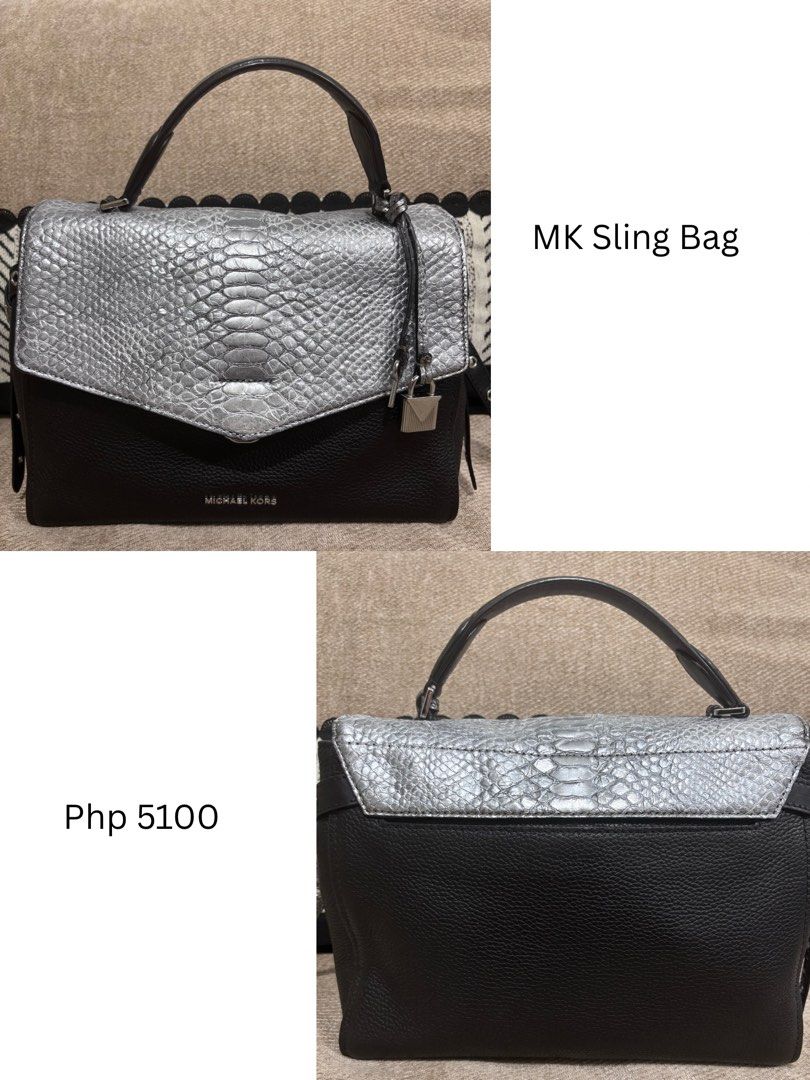 Michael Kors Black & Silver Textured Leather Handbag (Category: Luxury Bags & Wallets) located in Mandaluyong City. Submitted by annaziki2001 (Listing ID 1464573073, Image 1). Description: - Michael Kors black pebbled leather handbag - Silver textured flap with twist lock closure - Top handle and detachable shoulder strap included - Multiple interior compartments and zip pockets - Michael Kors logo detail on front and inside - Original strap is i