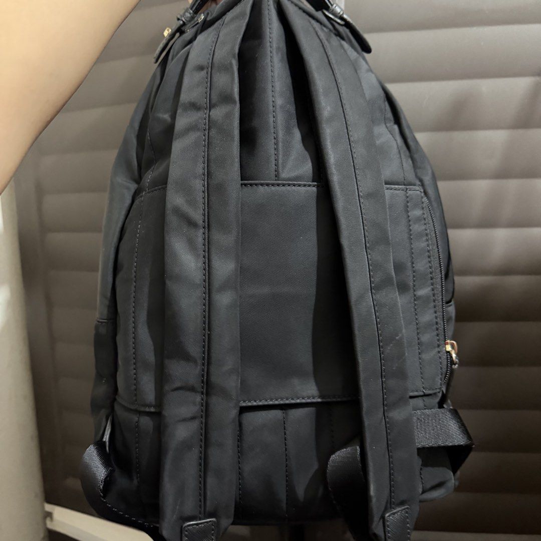 Michael Kors Black Nylon Backpack with Gold Hardware (Category: Backpacks) located in Rizal. Submitted by lovegclothingph (Listing ID 1467103622, Image 3). Description: - Brand: Michael Kors - Material: Durable black nylon with Saffiano leather top handle and trim - Hardware: Premium gold-tone hardware with front metal lock charm - Exterior: Convenient front zippered pocket - Interior: Main compartment with zippered inner pocket and multiple slip