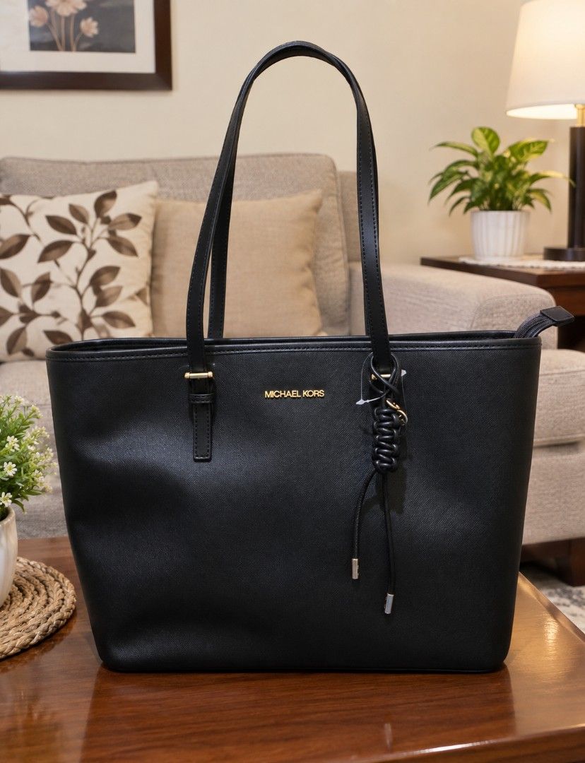 Michael Kors Black Tote Bag (Category: Tote Bags) located in Rizal. Submitted by pispis190611 (Listing ID 1467100579, Image 1). Description: - Brand: Michael Kors - Material: Premium black saffiano leather - Hardware: Elegant gold-toned accents with front logo stamp - Straps: Double shoulder straps with adjustable buckles - Details: Chic braided leather hanging accent - Closure: Secure zip-top closure - Condition: Excellent / Well-maintained - Pe