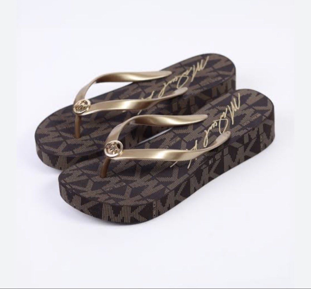Michael Kors Brown Monogram Flip Flops (Category: Slippers and slides) located in Manila. Submitted by thebelle8 (Listing ID 1467161984, Image 2). Description: - Brand: Michael Kors - Style: Platform flip-flops / slip-ons - Color/Design: Classic brown monogram print with script signature footbed - Details: Gold-tone straps featuring center MK logo hardware - Best for: Warm weather, vacations, and beach days - Condition: Excellent / ready to wear.