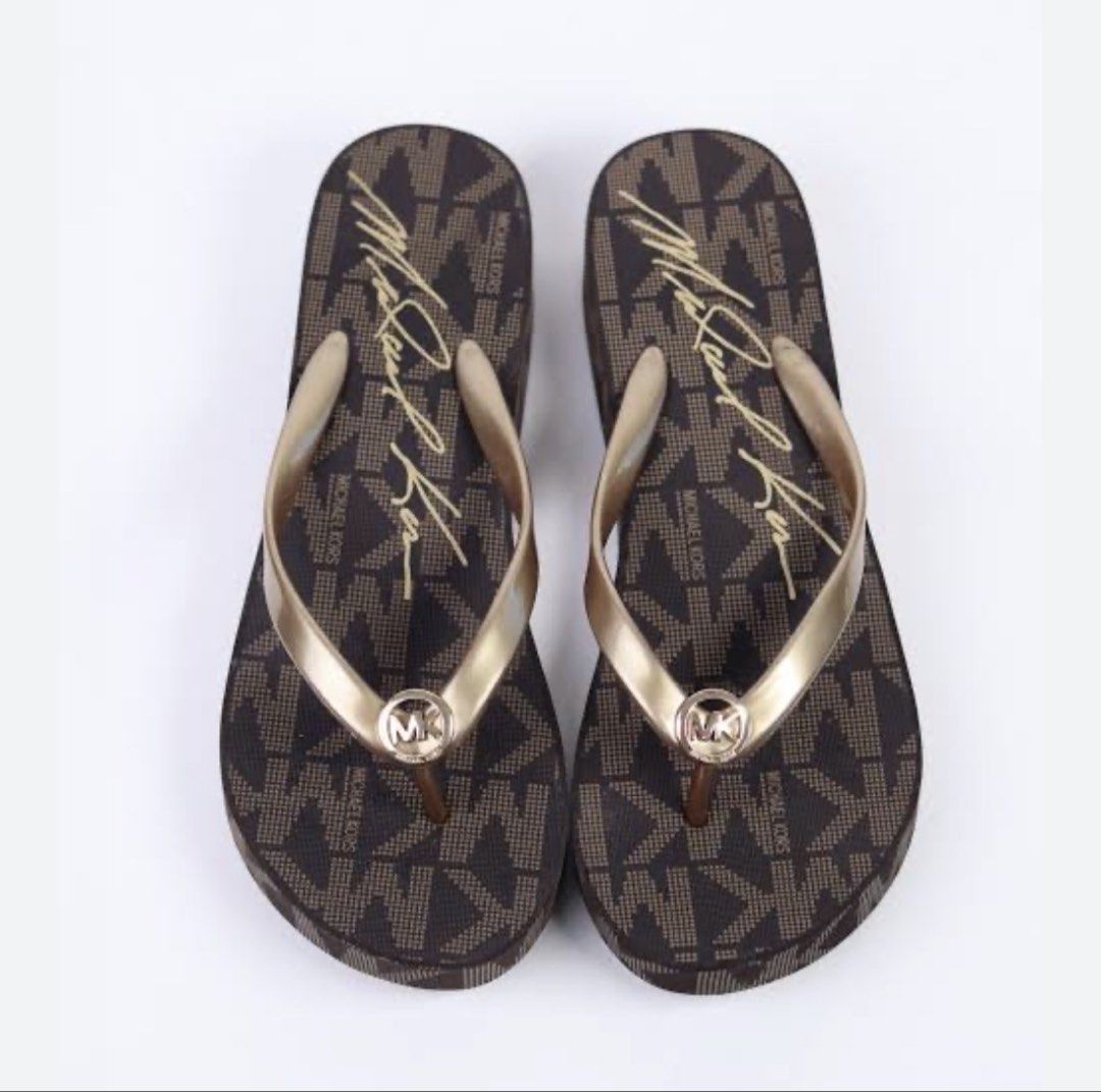 Michael Kors Brown Monogram Flip Flops (Category: Slippers and slides) located in Manila. Submitted by thebelle8 (Listing ID 1467161984, Image 1). Description: - Brand: Michael Kors - Style: Platform flip-flops / slip-ons - Color/Design: Classic brown monogram print with script signature footbed - Details: Gold-tone straps featuring center MK logo hardware - Best for: Warm weather, vacations, and beach days - Condition: Excellent / ready to wear.