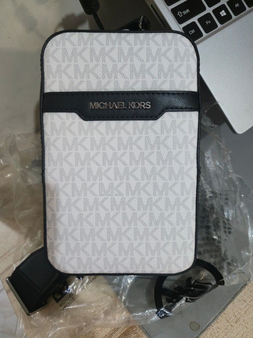 Michael Kor's Cooper Medium Signature Logo Sling Pack (Category: Sling Bags) located in Quezon City. Submitted by karlleseshops (Listing ID 1467113208, Image 2). Description: Michael Kor's Cooper Medium Signature Logo Sling Pack original from US. Details • Sling pack • Logo-print canvas • 89.4% coated canvas/9.6% polyester/1% polyurethane • Gunmetal hardware • 5.1”W X 10.6”H X 2”D • Exterior details: front slip pocket • Interior details: phone po