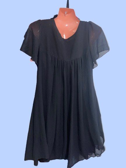 MINGYIREN Black Chiffon Mini Dress (Category: Dresses) located in Manila. Submitted by joclutter (Listing ID 1467083397, Image 2). Description: - Brand: MINGYIREN - Style: Black chiffon mini dress with a flowy, loose silhouette - Details: Scoop neckline, short sheer flutter sleeves, and a gathered pleated bodice - Comfort: Lightweight fabric, fully lined body, and easy pull-on style (no zippers or buttons) - Length: Above the knee - Condition: Ex