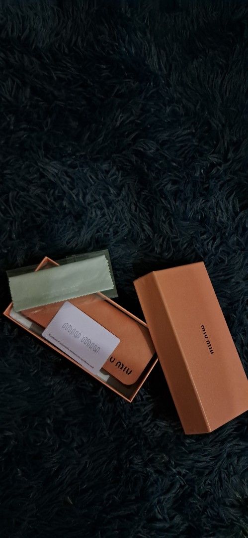 Miu Miu Black Eyeglasses with Case (Category: Luxury Accessories) located in Agdangan. Submitted by crinee_ (Listing ID 1467152411, Image 2). Description: - Color: Black frames with stylish gold accents near the hinges - Lenses: Clear lenses installed (ideal for daily prescription or fashion wear) - Condition: Clean overall condition - Inclusions: Complete set with pink branded box, leather case, cleaning cloth, and authenticity card.