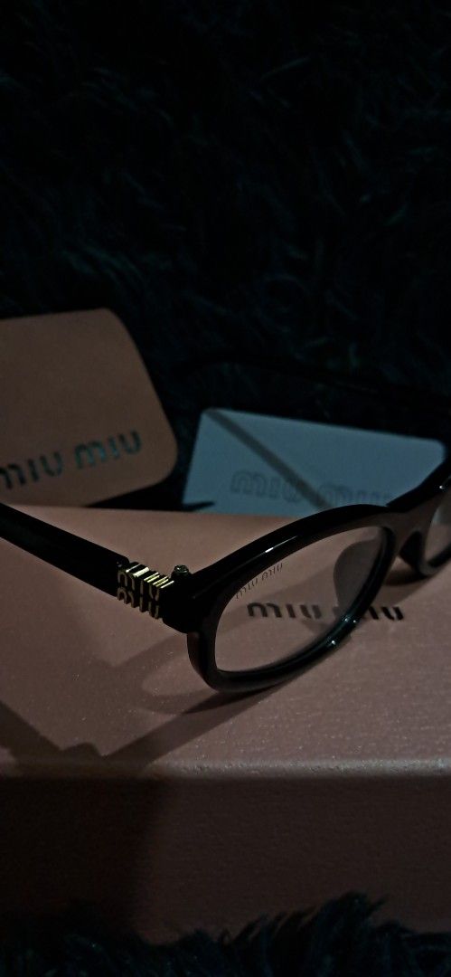 Miu Miu Black Eyeglasses with Case (Category: Luxury Accessories) located in Agdangan. Submitted by crinee_ (Listing ID 1467152411, Image 1). Description: - Color: Black frames with stylish gold accents near the hinges - Lenses: Clear lenses installed (ideal for daily prescription or fashion wear) - Condition: Clean overall condition - Inclusions: Complete set with pink branded box, leather case, cleaning cloth, and authenticity card.