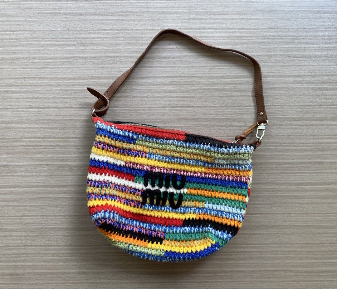 Miu Miu Multi-color Crochet Shoulder Bag (Category: Shoulder Bags) located in Binalbagan. Submitted by veraguasjo37518 (Listing ID 1467083297, Image 1). Description: - Multi-color crochet shoulder bag with vibrant striped yarn pattern - Durable brown leather strap and secure zip top closure - Features a distinctive black Miu Miu logo patch on the front - Olive green fabric-lined interior with a convenient slip pocket - Includes a small embossed l