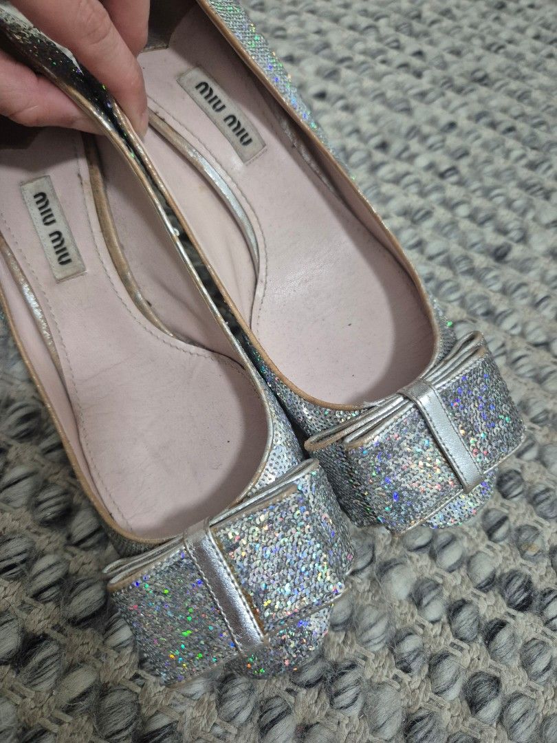 Miu Miu Silver Sequin Bow Pumps Size 37 (Category: Sneakers & Footwear) located in Quezon City. Submitted by 53888 (Listing ID 1467149684, Image 2). Description: - Brand: Miu Miu (Made in Italy) - Size: 37 - Material & Design: Silver holographic sequins with a chunky block heel and adorable toe bow - Details: Pink leather insoles with stamped brand logo - Condition: Pre-loved, worn a few times with minor creasing and slight wear on the inner lini
