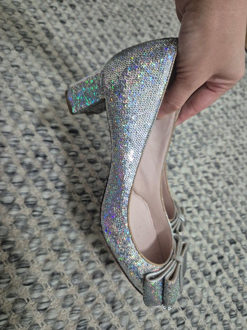 Miu Miu Silver Sequin Bow Pumps Size 37 (Category: Sneakers & Footwear) located in Quezon City. Submitted by 53888 (Listing ID 1467149684, Image 3). Description: - Brand: Miu Miu (Made in Italy) - Size: 37 - Material & Design: Silver holographic sequins with a chunky block heel and adorable toe bow - Details: Pink leather insoles with stamped brand logo - Condition: Pre-loved, worn a few times with minor creasing and slight wear on the inner lini