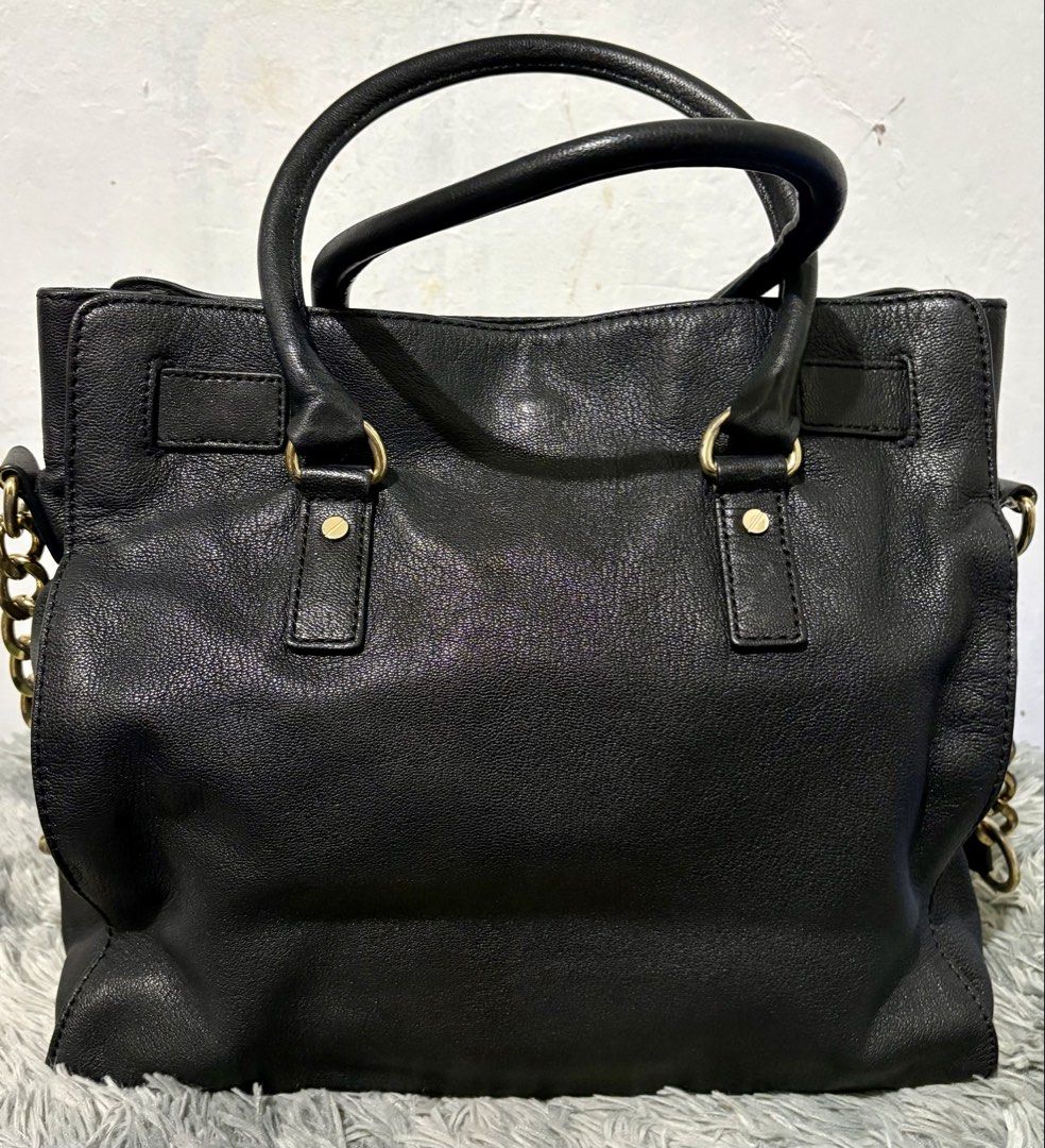 MK Hamilton (Category: Luxury Bags & Wallets) located in Manila. Submitted by jlj_v.2_oshop (Listing ID 1467007155, Image 2). Description: Original MICHAEL Michael Kors Hamilton East/West Satchel Bag featuring gold-tone hardware, dual top handles, a chain shoulder strap, and a signature padlock closure. Large size. .