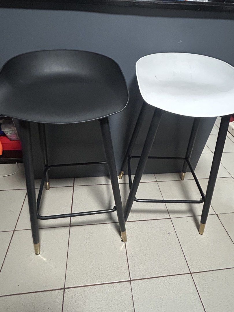 Modern Bar Stools Black and White Set (Category: Chairs) located in Manila. Submitted by thrift_items_need (Listing ID 1467131423, Image 1). Description: - Set of 2 modern bar stools (1 black, 1 white) - Sturdy black metal legs with stylish gold-capped feet - Built-in footrests on all sides for extra sitting comfort - Smooth, contoured plastic seats for easy cleaning - Clean, minimalist design ideal for kitchen islands or home bars - Selling as a
