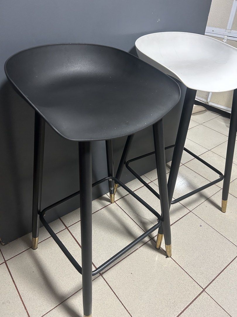 Modern Bar Stools Black and White Set (Category: Chairs) located in Manila. Submitted by thrift_items_need (Listing ID 1467131423, Image 2). Description: - Set of 2 modern bar stools (1 black, 1 white) - Sturdy black metal legs with stylish gold-capped feet - Built-in footrests on all sides for extra sitting comfort - Smooth, contoured plastic seats for easy cleaning - Clean, minimalist design ideal for kitchen islands or home bars - Selling as a
