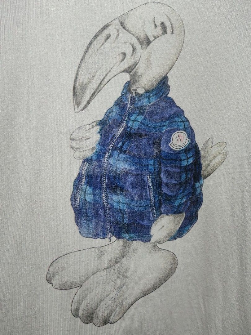 Moncler Graphic Dodo Bird Tee (Category: Shirts) located in Donsol. Submitted by saksthriftavenuebyluckymaria8 (Listing ID 1466977453, Image 3). Description: - Brand: Moncler - Color: off white - Design: Dodo bird graphic on front with sleeve logo patch and tricolor neckline tab - Fit: Short sleeves, classic crew neck - Material: Premium soft cotton, durable stitching - Condition: Clean, crisp prints, well-maintained size xl fits L chest 21 in ar