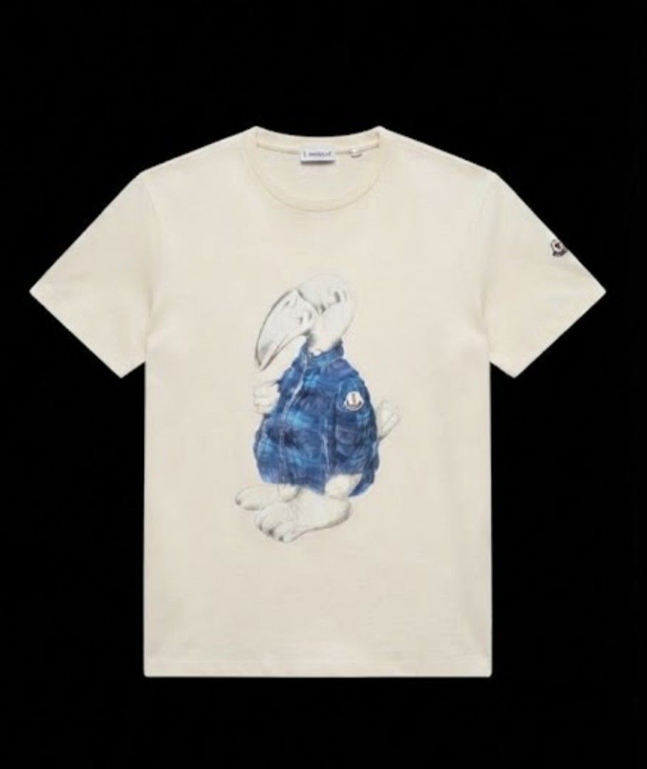Moncler Graphic Dodo Bird Tee (Category: Shirts) located in Donsol. Submitted by saksthriftavenuebyluckymaria8 (Listing ID 1466977453, Image 1). Description: - Brand: Moncler - Color: off white - Design: Dodo bird graphic on front with sleeve logo patch and tricolor neckline tab - Fit: Short sleeves, classic crew neck - Material: Premium soft cotton, durable stitching - Condition: Clean, crisp prints, well-maintained size xl fits L chest 21 in ar