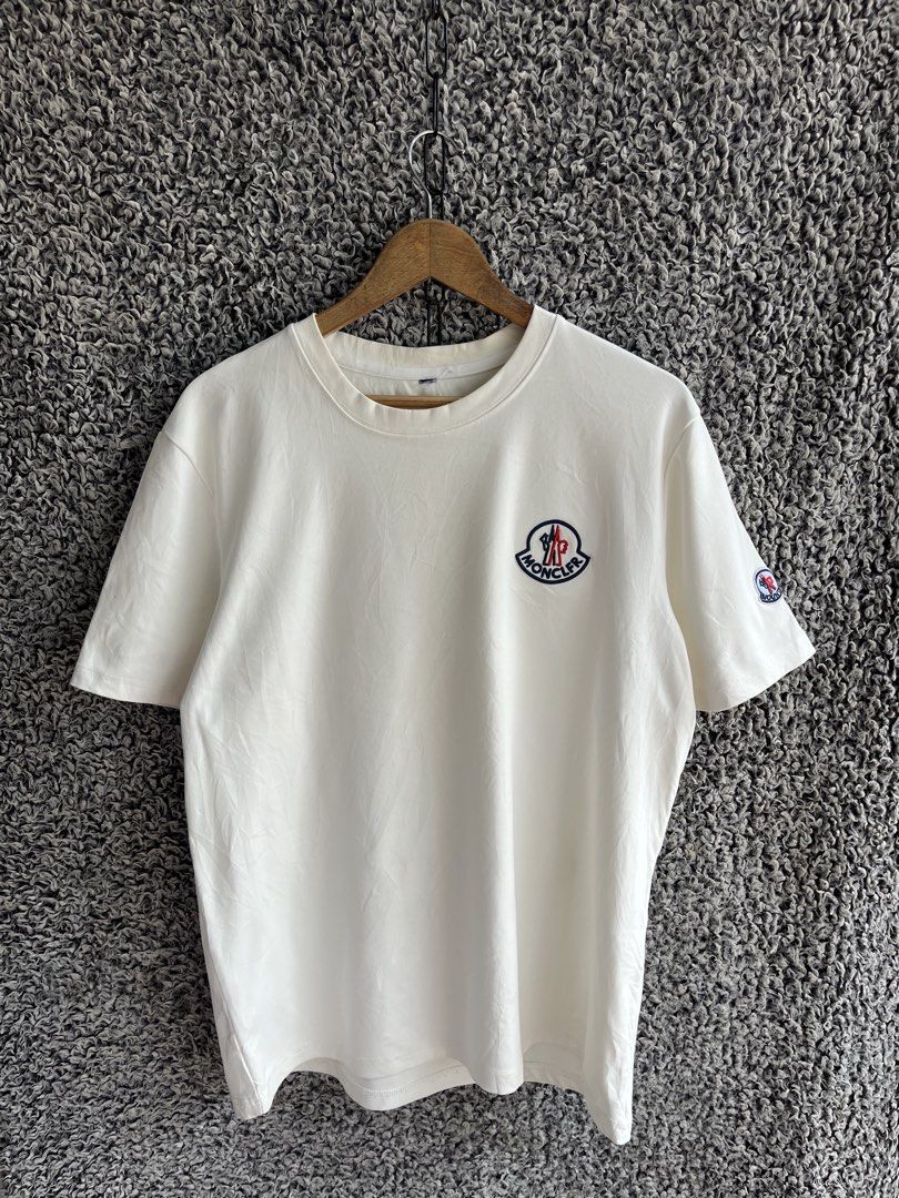 Moncler short-sleeve crew-neck | Size M (Category: Tshirts & Polo Shirts ) located in General Trias. Submitted by zrchustle.604 (Listing ID 1466975643, Image 1). Description: Moncler short-sleeve crew-neck cotton T-shirt in an off-white or eggshell color featuring an embroidered logo patch on the chest and a smaller logo detail on the sleeve..