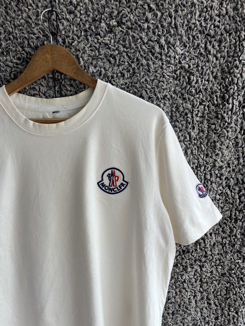 Moncler short-sleeve crew-neck | Size M (Category: Tshirts & Polo Shirts ) located in General Trias. Submitted by zrchustle.604 (Listing ID 1466975643, Image 2). Description: Moncler short-sleeve crew-neck cotton T-shirt in an off-white or eggshell color featuring an embroidered logo patch on the chest and a smaller logo detail on the sleeve..