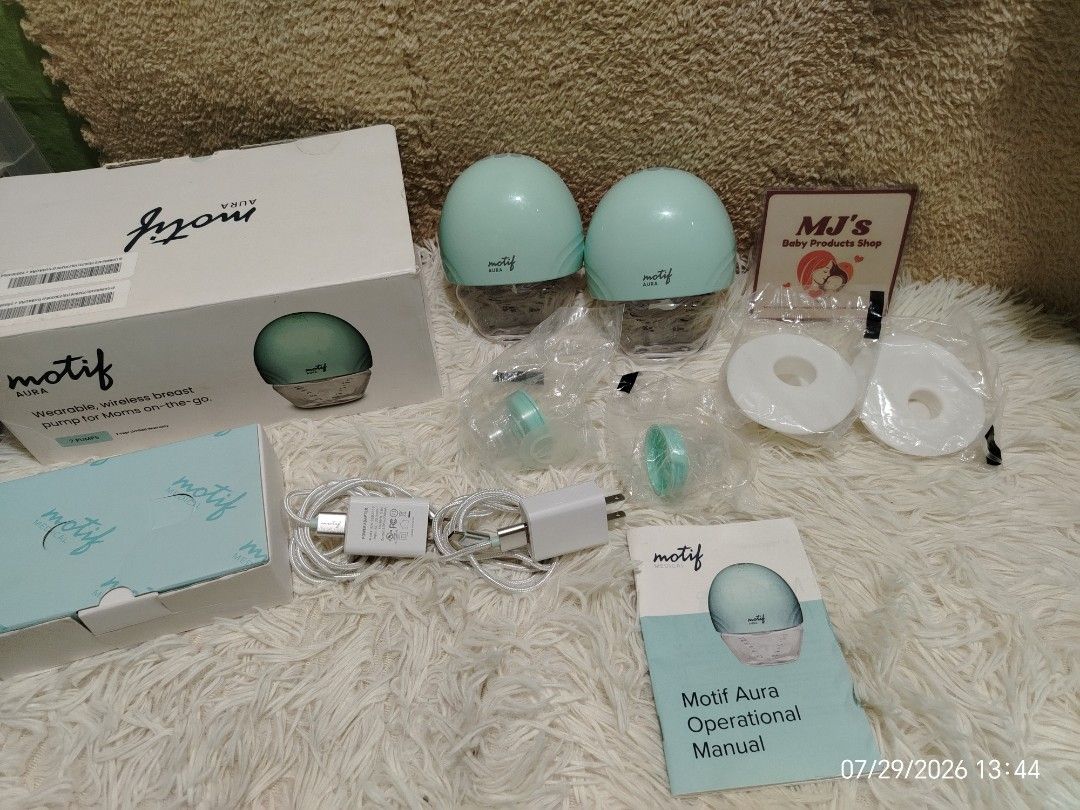 Motif Aura Wearable Breast Pump Set (Category: Breastfeeding & Bottle Feeding) located in Pulilan. Submitted by mjbabyproductsshop (Listing ID 1467042010, Image 1). Description: - Brand: Motif Aura - Type: Double wearable breast pump - Color: Mint green - Condition: Complete set with original box and manual - Included: 2 pump motors, collection containers, charging cables, and extra parts in sealed bags - Features: Clear digital display screens, 
