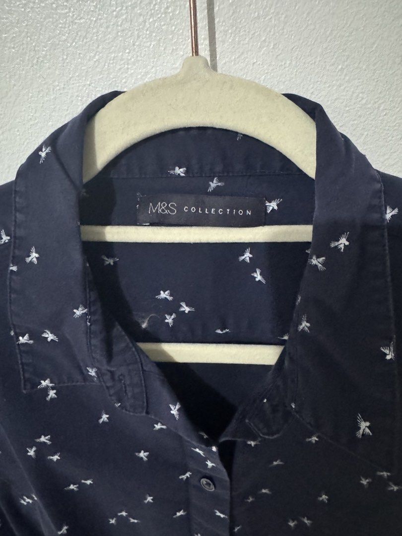 Marks & Spencer Collection Polo (Category: Blouses) located in Pasig City. Submitted by pmlmri (Listing ID 1467155757, Image 2). Description: - Brand: Marks & Spencer Collection - Style: Short sleeve button-down blouse - Color/Pattern: Navy blue with an all-over white bird/insect print - Condition: Excellent pre-loved condition Mode of Shipping: J&T or Lalamove Mode of Payment: Gotyme/BPI/Gcash.