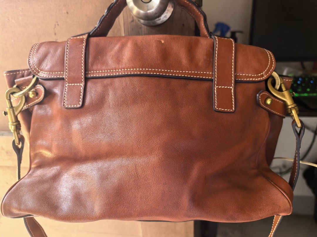 Mulberry Brown Leather Satchel Bag (Category: Luxury Bags & Wallets) located in Cagayan de Oro. Submitted by tommygurl1218 (Listing ID 1467011856, Image 3). Description: - Authentic brown leather Mulberry satchel bag - Structured front flap with double buckle straps and classic postman's lock - Antique brass hardware with sturdy top handle - Includes a detachable shoulder strap with swivel clasp hardware - Condition: Shows visible natural leather