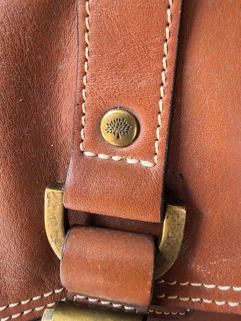 Mulberry Brown Leather Satchel Bag (Category: Luxury Bags & Wallets) located in Cagayan de Oro. Submitted by tommygurl1218 (Listing ID 1467011856, Image 2). Description: - Authentic brown leather Mulberry satchel bag - Structured front flap with double buckle straps and classic postman's lock - Antique brass hardware with sturdy top handle - Includes a detachable shoulder strap with swivel clasp hardware - Condition: Shows visible natural leather