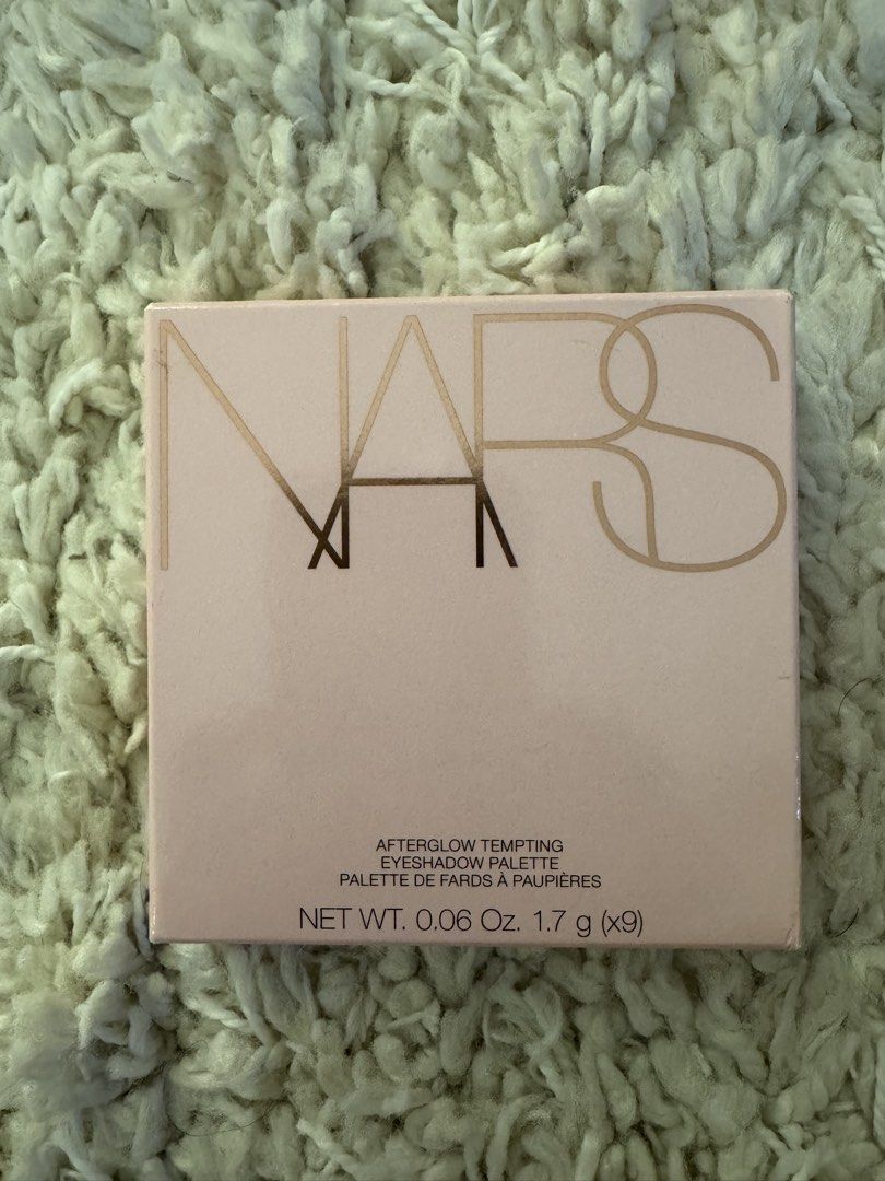 NARS Afterglow Tempting Eyeshadow Palette (Category: Makeup) located in San Nicolas. Submitted by ihascat (Listing ID 1467020492, Image 3). Description: - Brand: NARS - Product: Afterglow Tempting Eyeshadow Palette - Condition: Brand new, never opened or swatched, pristine retail condition - Shades: 9 versatile shades including pinks, taupes, and warm browns - Finishes: A mix of gorgeous shimmer and matte finishes - Features: Built-in compact mir