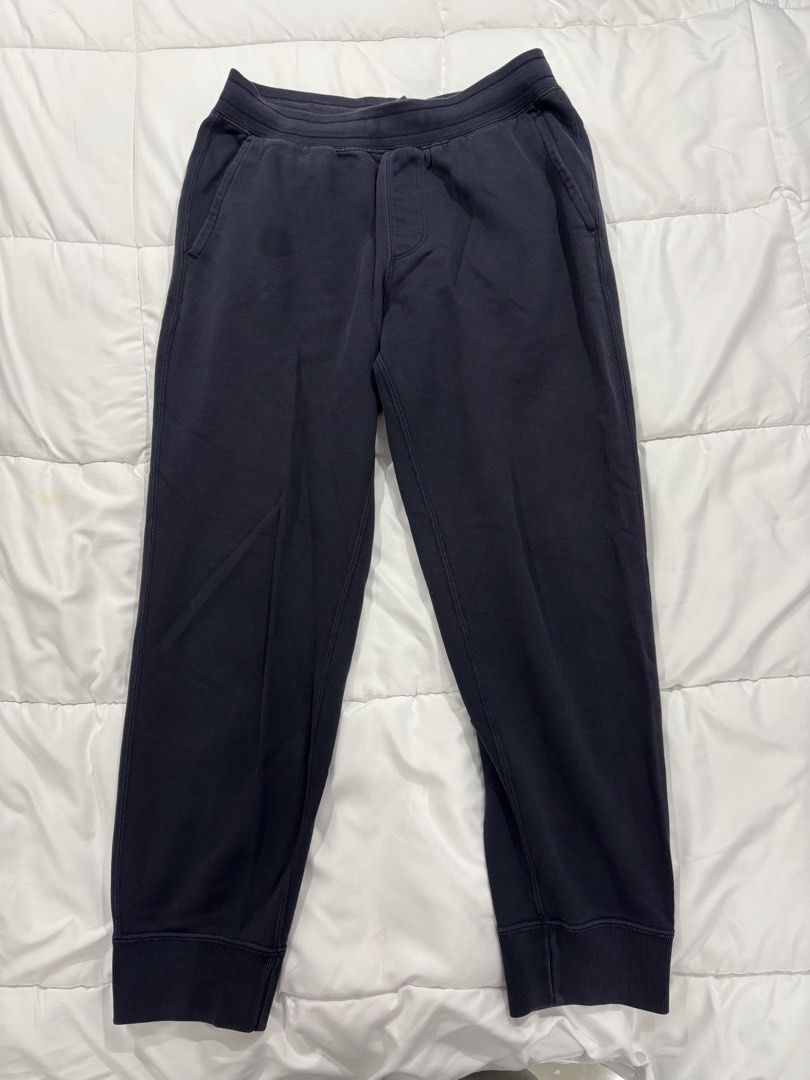 Navy Blue Joggers Drawstring Cuffed Sweatpants (Category: Joggers) located in Manila. Submitted by ethannn_p (Listing ID 1467059553, Image 1). Description: - Color: Navy blue - Material: Soft cotton with cozy fleece lining - Fit: Relaxed fit with ribbed ankle cuffs - Waistband: Adjustable drawstring for a secure fit - Pockets: Two side pockets and one back patch pocket - Condition: Regular wash wear with minor fading along the seams - Perfect for