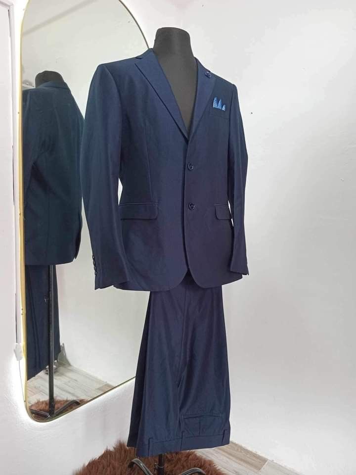 Navy Blue Two-Piece Suit Jacket and Pants Set (Category: Sets or Coordinates) located in Dasmarinas. Submitted by sagalagown66473 (Listing ID 1467001812, Image 1). Description: - Color: Solid navy blue - Set includes: Suit jacket and matching trousers - Jacket details: Two-button closure, standard notch lapels, flap pockets, breast pocket with patterned pocket square - Condition: Clean fabric, no stains or fraying - Ideal for: Formal events, wedd