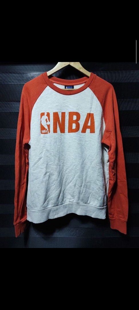 NBA Orange and Grey Raglan Sweatshirt Not Nike (Category: Coats, Jackets and Outerwear) located in Pasig City. Submitted by abogadosupremo (Listing ID 1467149116, Image 1). Description: - Authentic NBA crewneck sweatshirt - Colorway: Orange sleeves and collar with grey marled body - Large red NBA logo printed on the front chest - 100% pure cotton for comfort and breathability - Relaxed fit with classic ribbed cuffs and hem - Perfect for casual we