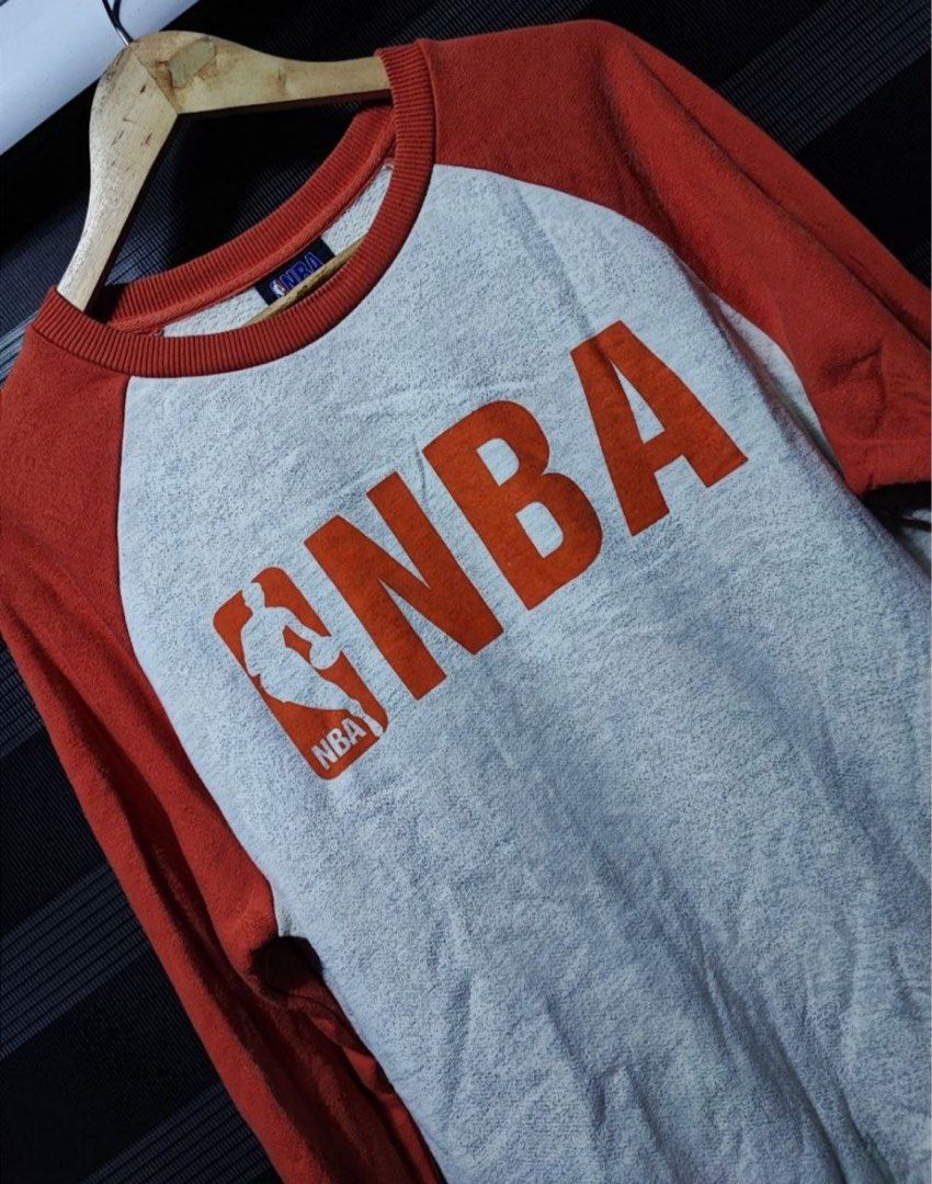 NBA Orange and Grey Raglan Sweatshirt Not Nike (Category: Coats, Jackets and Outerwear) located in Pasig City. Submitted by abogadosupremo (Listing ID 1467149116, Image 2). Description: - Authentic NBA crewneck sweatshirt - Colorway: Orange sleeves and collar with grey marled body - Large red NBA logo printed on the front chest - 100% pure cotton for comfort and breathability - Relaxed fit with classic ribbed cuffs and hem - Perfect for casual we
