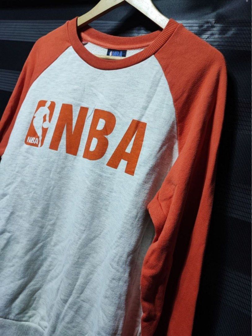 NBA Orange and Grey Raglan Sweatshirt Not Nike (Category: Coats, Jackets and Outerwear) located in Pasig City. Submitted by abogadosupremo (Listing ID 1467149116, Image 3). Description: - Authentic NBA crewneck sweatshirt - Colorway: Orange sleeves and collar with grey marled body - Large red NBA logo printed on the front chest - 100% pure cotton for comfort and breathability - Relaxed fit with classic ribbed cuffs and hem - Perfect for casual we