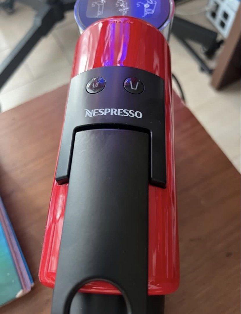 Nespresso Essenza Mini Red Coffee Machine (Category: Coffee Machines & Makers) located in Manila. Submitted by kai.168 (Listing ID 1467163659, Image 3). Description: - Model: Nespresso Essenza Mini - Color: Vibrant Red with a clean gloss finish - Design: Ultra-compact countertop footprint - Features: Two programmable cup size buttons, removable drip tray - Condition: Clean exterior, includes original barcode sticker on the back - Performance: Qui