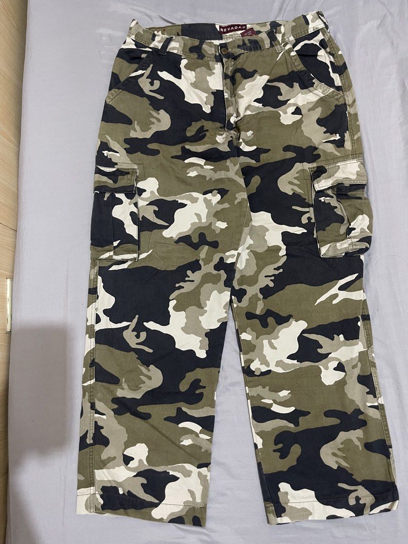 Nevada Camouflage Cargo Pants Size 38x33 (Category: Jeans) located in Cebu City. Submitted by meemaoo (Listing ID 1467147840, Image 1). Description: - Brand: Nevada - Size: Waist 38, Leg Length 33 - Material: 100% thick cotton canvas - Features: Multiple utility pockets, button closure, and belt loops - Condition: Great streetwear piece, sturdy and durable fabric -SF FEE SHOULDERED BY BUYER .