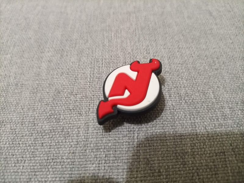 New Jersey Devils Crocs Jibbitz Shoe Charm (Category: Flats & Sandals) located in Quezon City. Submitted by susmaryosep1 (Listing ID 1467018930, Image 1). Description: - Design: Official New Jersey Devils red and white team logo - Compatibility: Fits all standard shoe ventilation holes (great for clogs and sandals) - Material: Durable, high-quality rubber - Use: Perfect for customizing footwear and showing your hockey support - Condition: Brand n