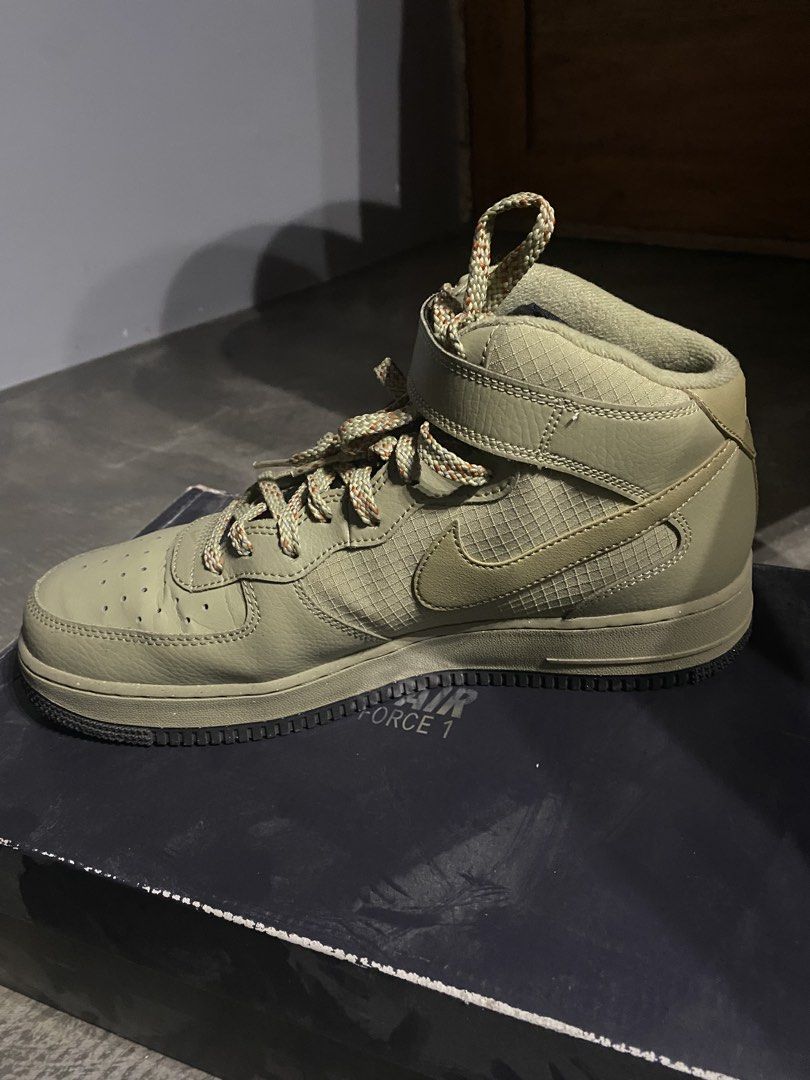 Nike Air Force 1 Mid '07 Neutral Olive (Category: Sneakers) located in Imus. Submitted by joaquinduq01043 (Listing ID 1467143975, Image 3). Description: - Brand: Nike Air Force 1 Mid '07 - Colorway: Neutral Olive - Size: US Men's 11 / US Women's 12.5 - Materials: Rugged canvas panels mixed with leather overlays - Features: Distinct speckled rope laces and secure velcro ankle strap - Inclusions: Complete with original box -slightly visible crease,