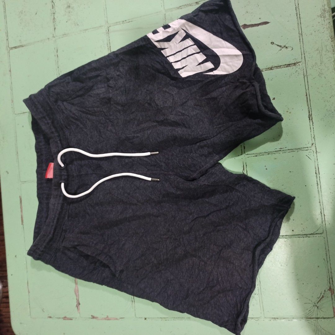 Nike Alumni (Category: Shorts) located in Tagbilaran City. Submitted by delasierra39181 (Listing ID 1467078532, Image 3). Description: - Brand: Nike - Color: Dark grey with large white swoosh logo - Size: XL (Recommended for height 175-185 cm) - Material: 100% cotton for ultimate comfort - Details: White drawstring waist with metal aglets - Origin: Made in China.