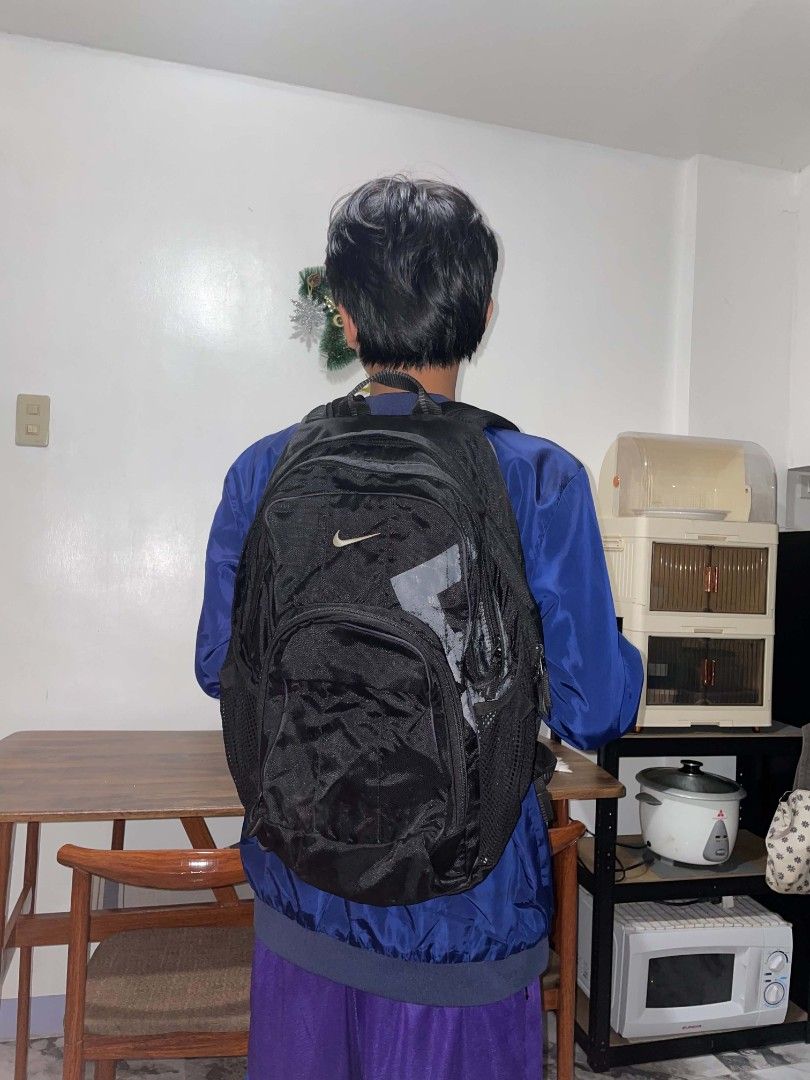 Nike Black Backpack with Multiple Compartments (Category: Backpacks) located in Manila. Submitted by mikeee03 (Listing ID 1467063271, Image 1). Description: - Authentic black Nike backpack with white swoosh logo - Multiple zippered compartments for easy organization - Convenient extra zippered pocket on the shoulder strap - Side mesh pockets for water bottles and small essentials - Padded back panel for all-day comfort and support - Durable build