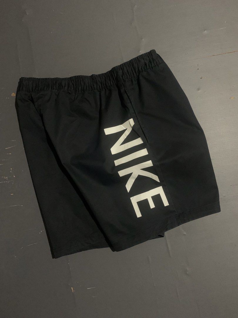 Nike Black Waffle Short (Category: Shorts) located in Dumaguete. Submitted by grrrpowww (Listing ID 1467166664, Image 3). Description: - Brand: Nike - Size: XL - Color: Black with white details - Design: Large vertical Nike logo on the back right leg - Storage: Practical cargo pocket on the left front leg with embroidered white swoosh - Fit/Style: Elastic waistband with white drawstring, comfortable for casual wear or workouts - Origin: Made in C