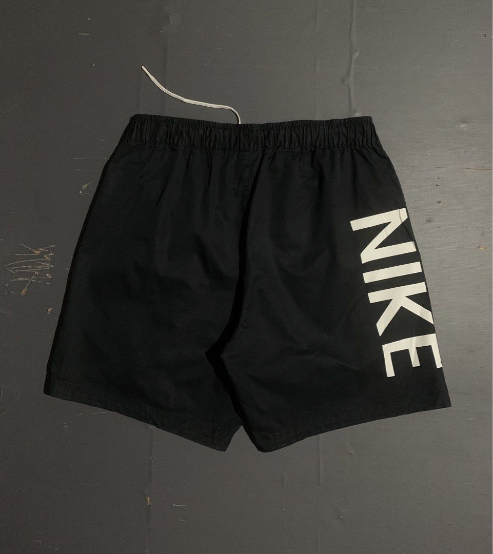 Nike Black Waffle Short (Category: Shorts) located in Dumaguete. Submitted by grrrpowww (Listing ID 1467166664, Image 1). Description: - Brand: Nike - Size: XL - Color: Black with white details - Design: Large vertical Nike logo on the back right leg - Storage: Practical cargo pocket on the left front leg with embroidered white swoosh - Fit/Style: Elastic waistband with white drawstring, comfortable for casual wear or workouts - Origin: Made in C